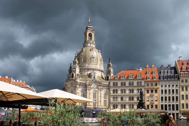 Historic church and buildings under stormy sky