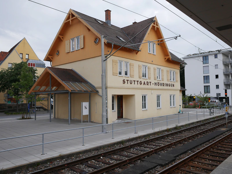 Small train station building with "stuttgart-heidingen" sign.