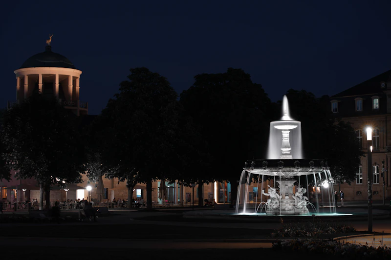 Illuminated fountain in a park at night.
